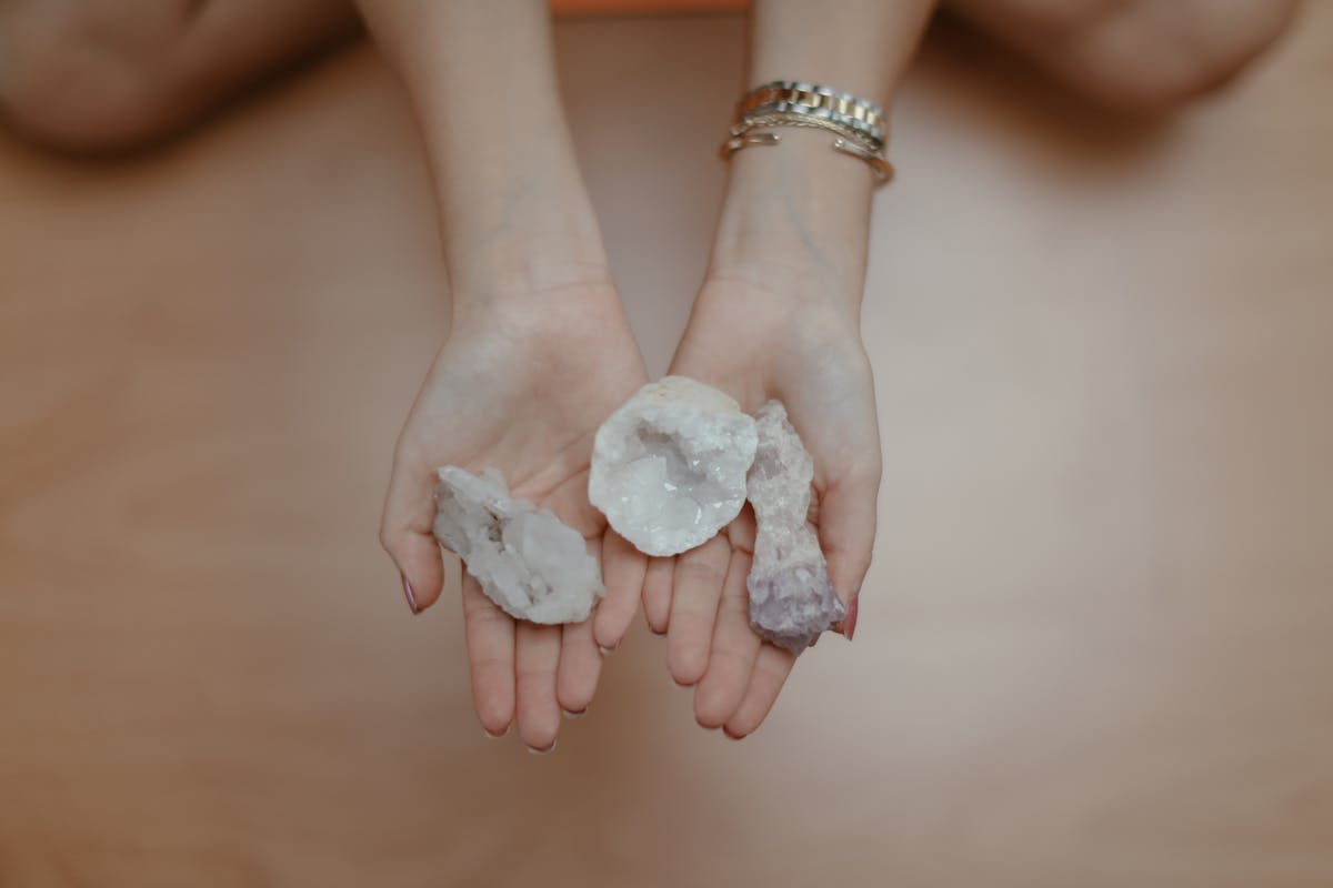 A person holding a bunch of crystals in their hands